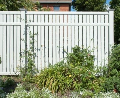 White fence with garden in front