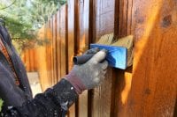 Image of man painting a fence